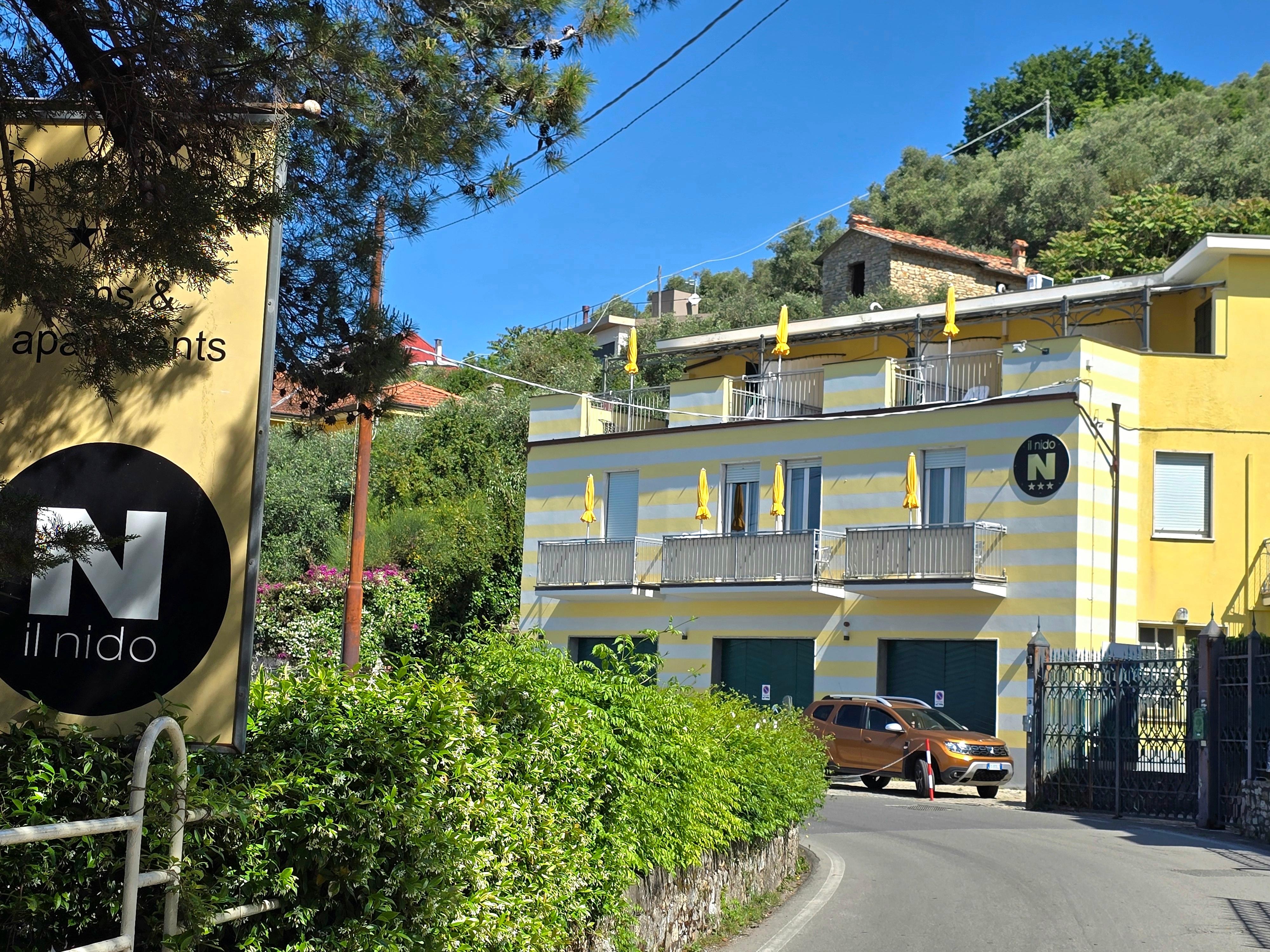 This is a view of the hotel reception on the left and apartments & parking on the right as you are heading back up the hill from town