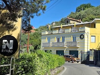 This is a view of the hotel reception on the left and apartments & parking on the right as you are heading back up the hill from town