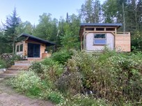 Cabin and outhouse. Outhouse had newly installed outdoor shower attached to it that used rain barrel recycling water!