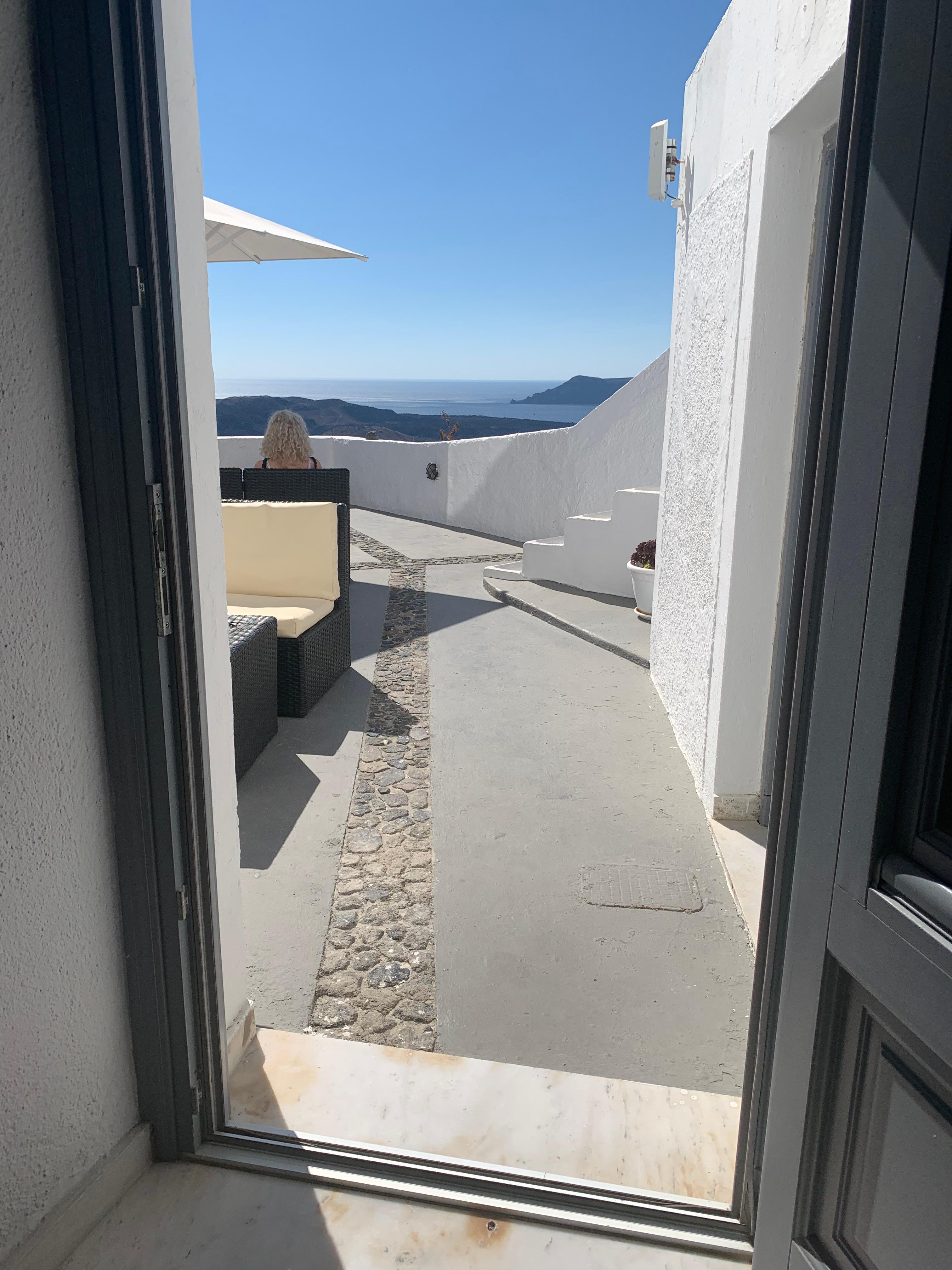 View from inside the room towards patio & sea.