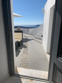 View from inside the room towards patio & sea.