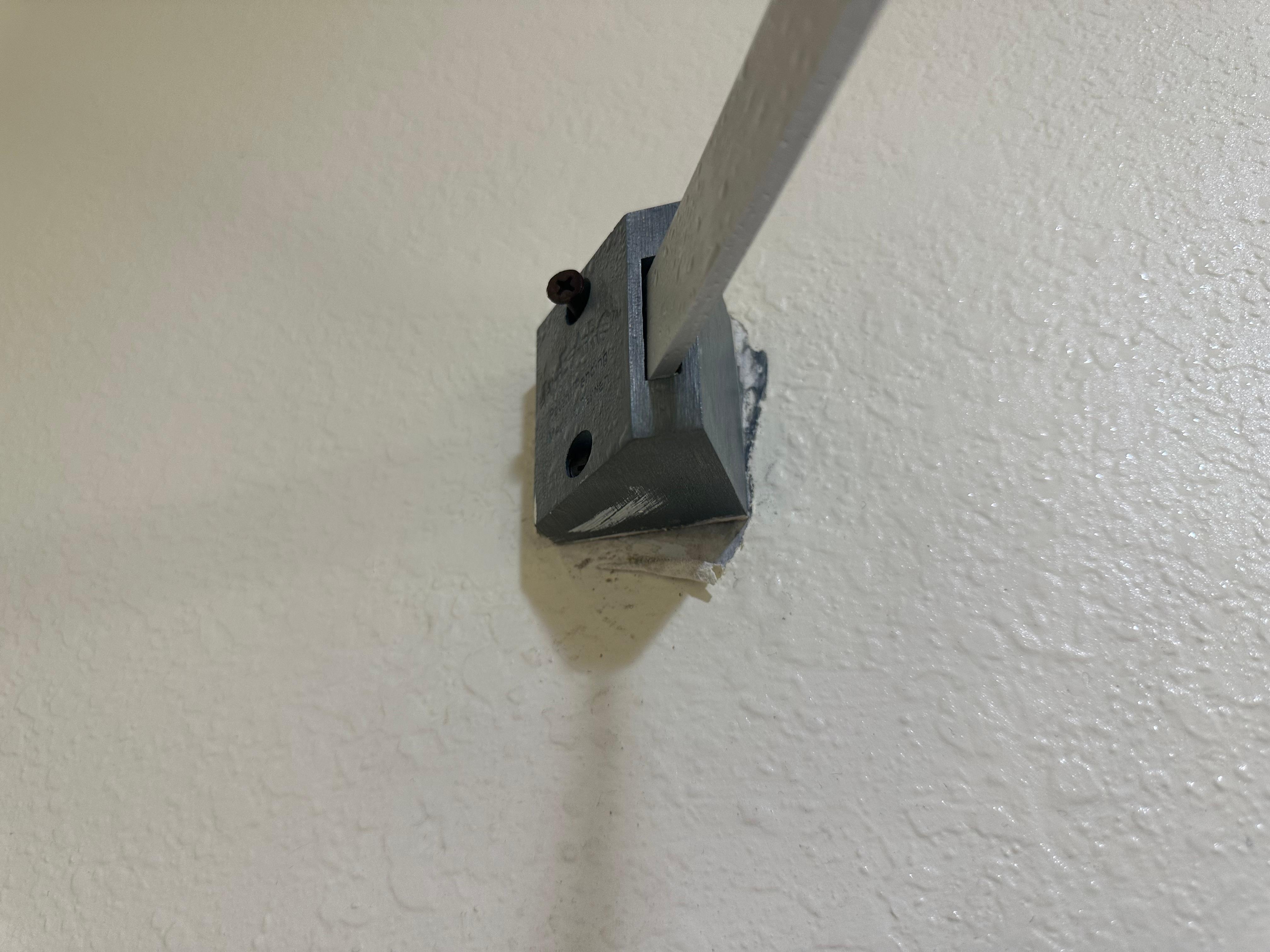 Shower curtain coming off the wall.