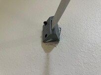 Shower curtain coming off the wall.