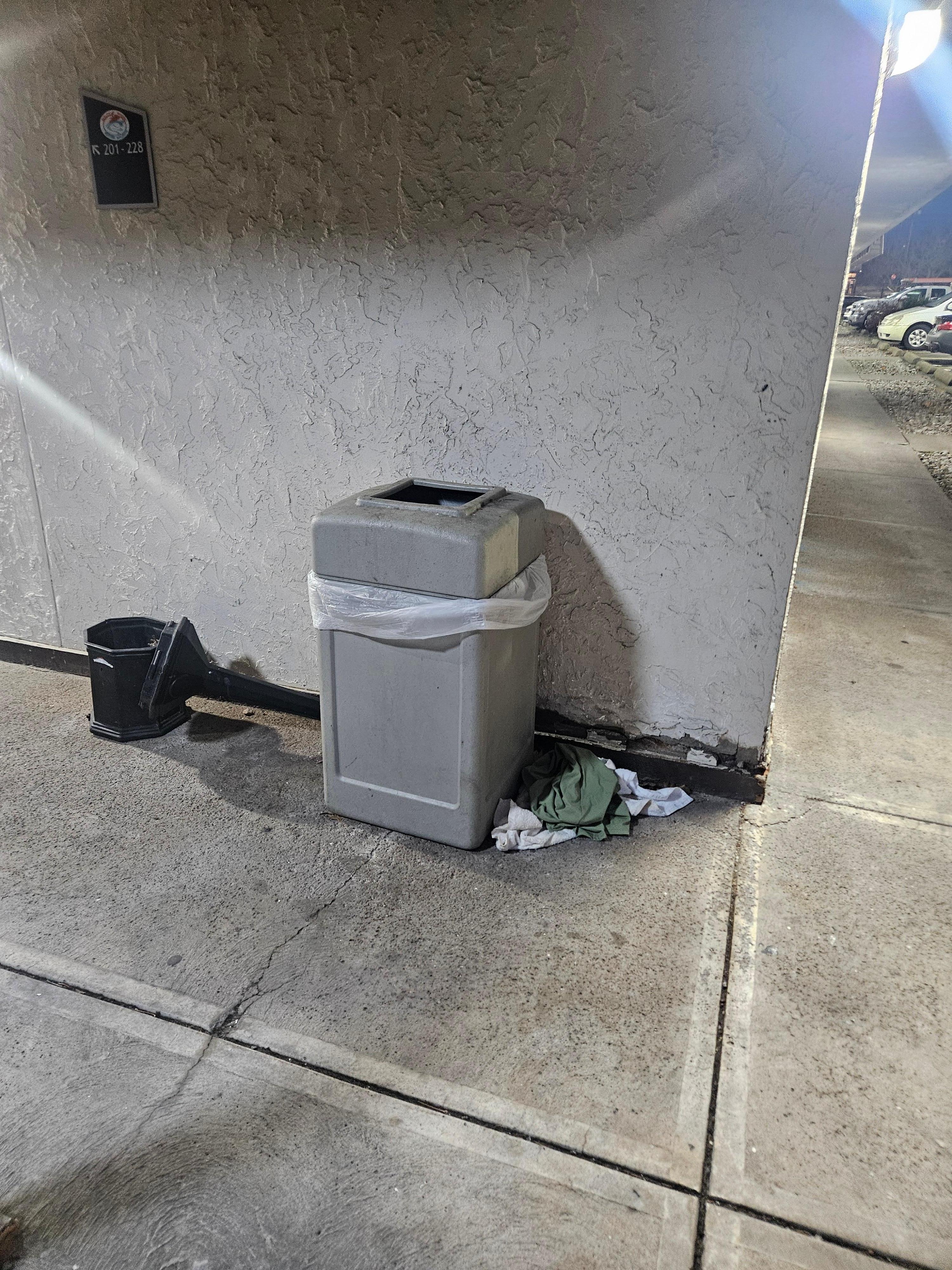 Linens or clothing on ground, smoke tower dump over