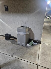 Linens or clothing on ground, smoke tower dump over