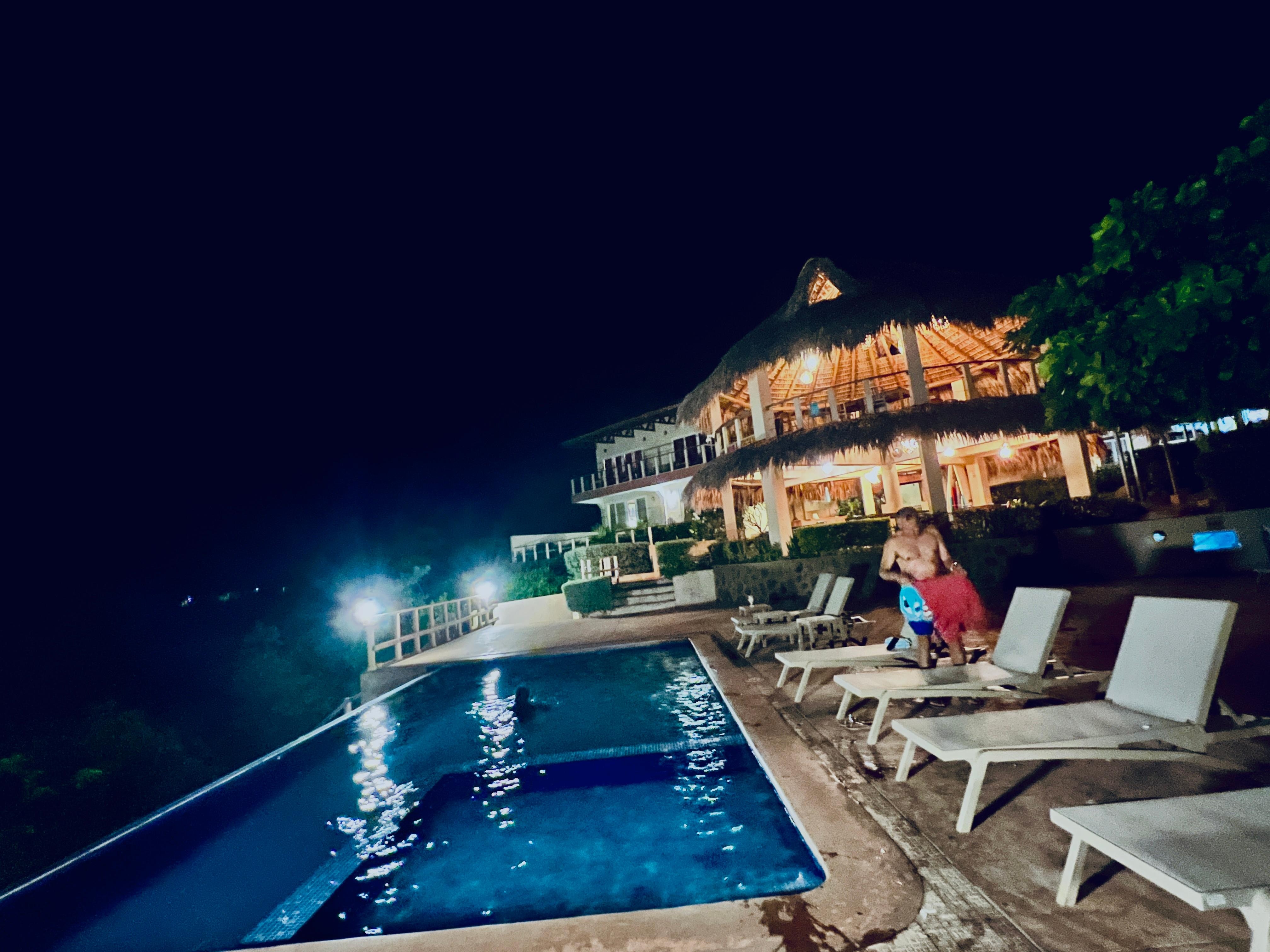 Night view of pool and terrace