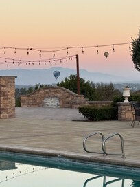 Backyard pool area. With balloons flying in the background