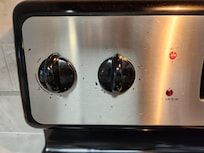 Knobs on the left side of the stove