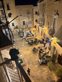 Balcony view of charming and lively piazza below.