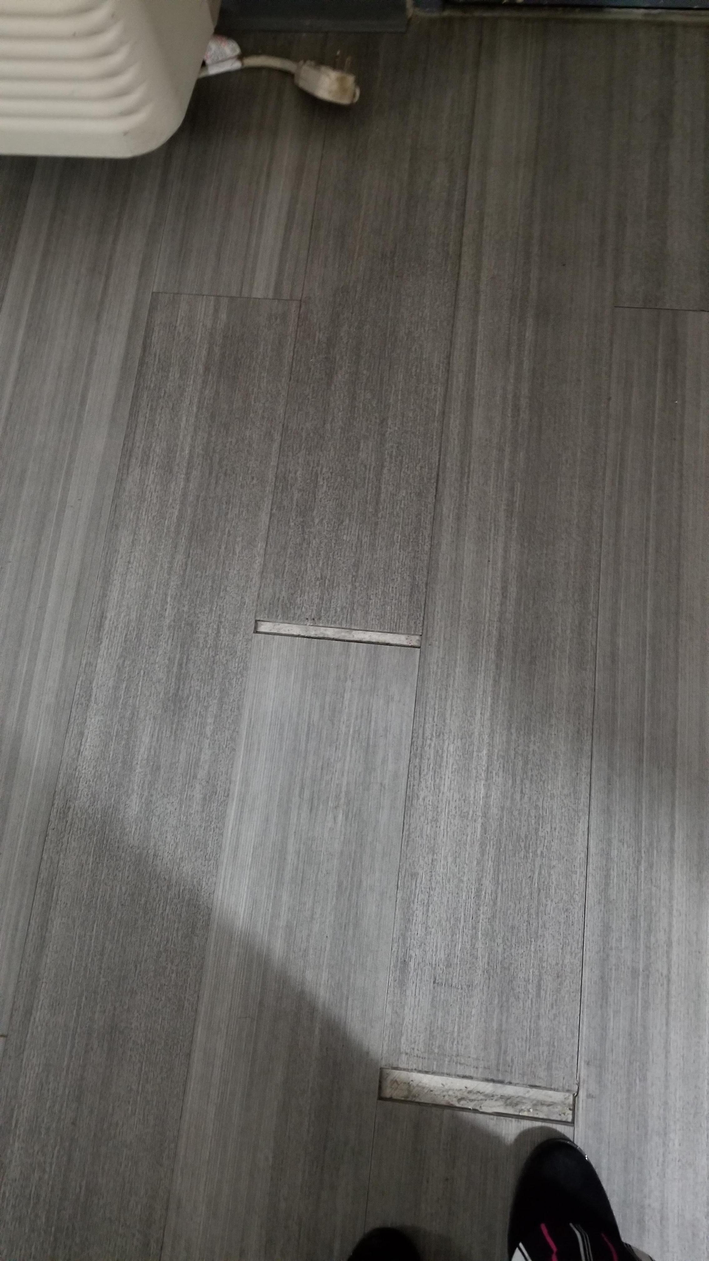 Separated flooring creating slip/trip/fall hazard