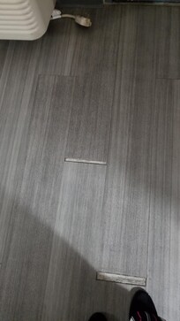 Separated flooring creating slip/trip/fall hazard