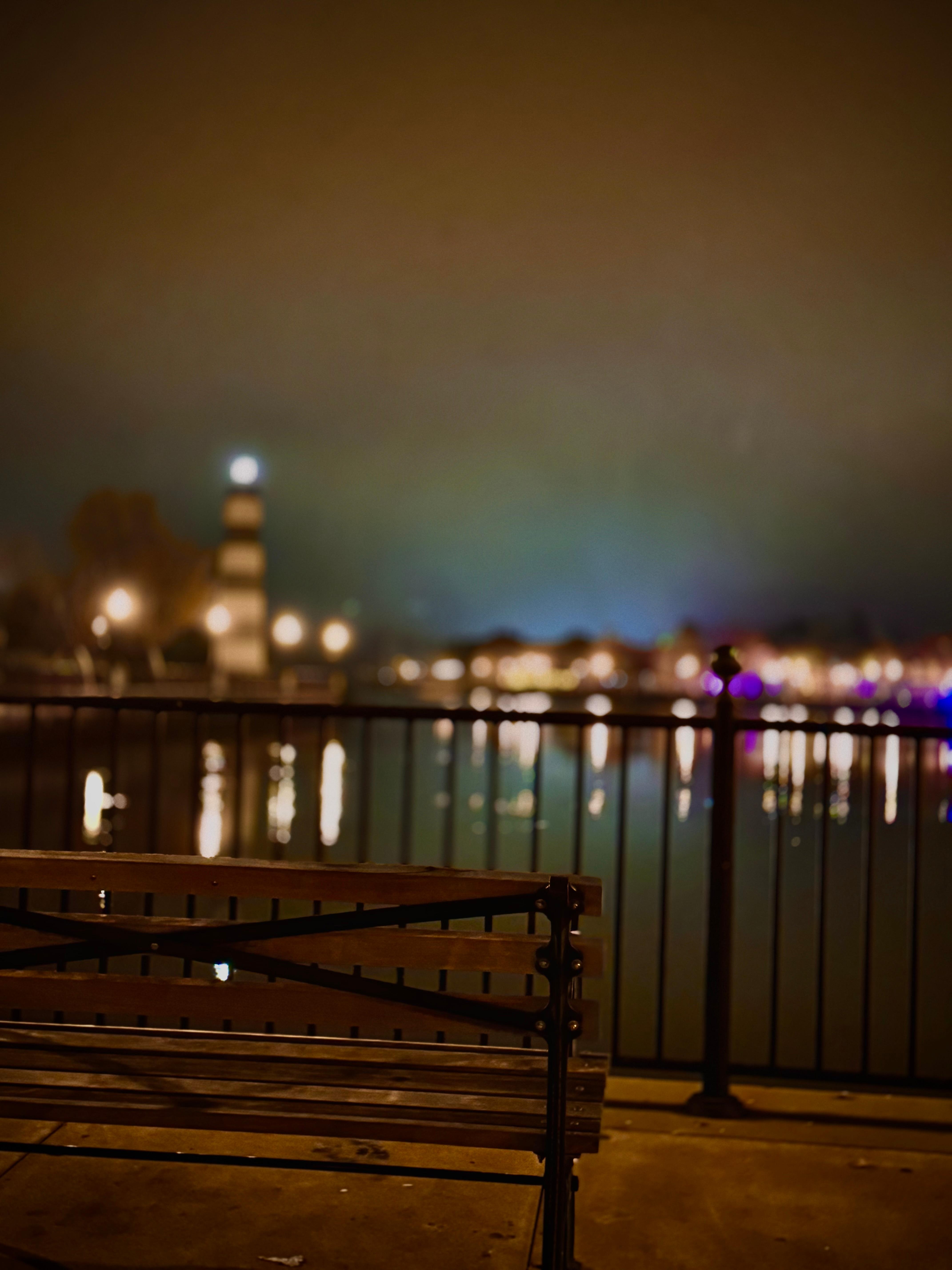 Light house, Mai Roma and police station visible with benches lining the walkway