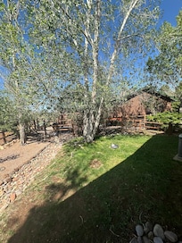 Beautiful yard with trees and views.