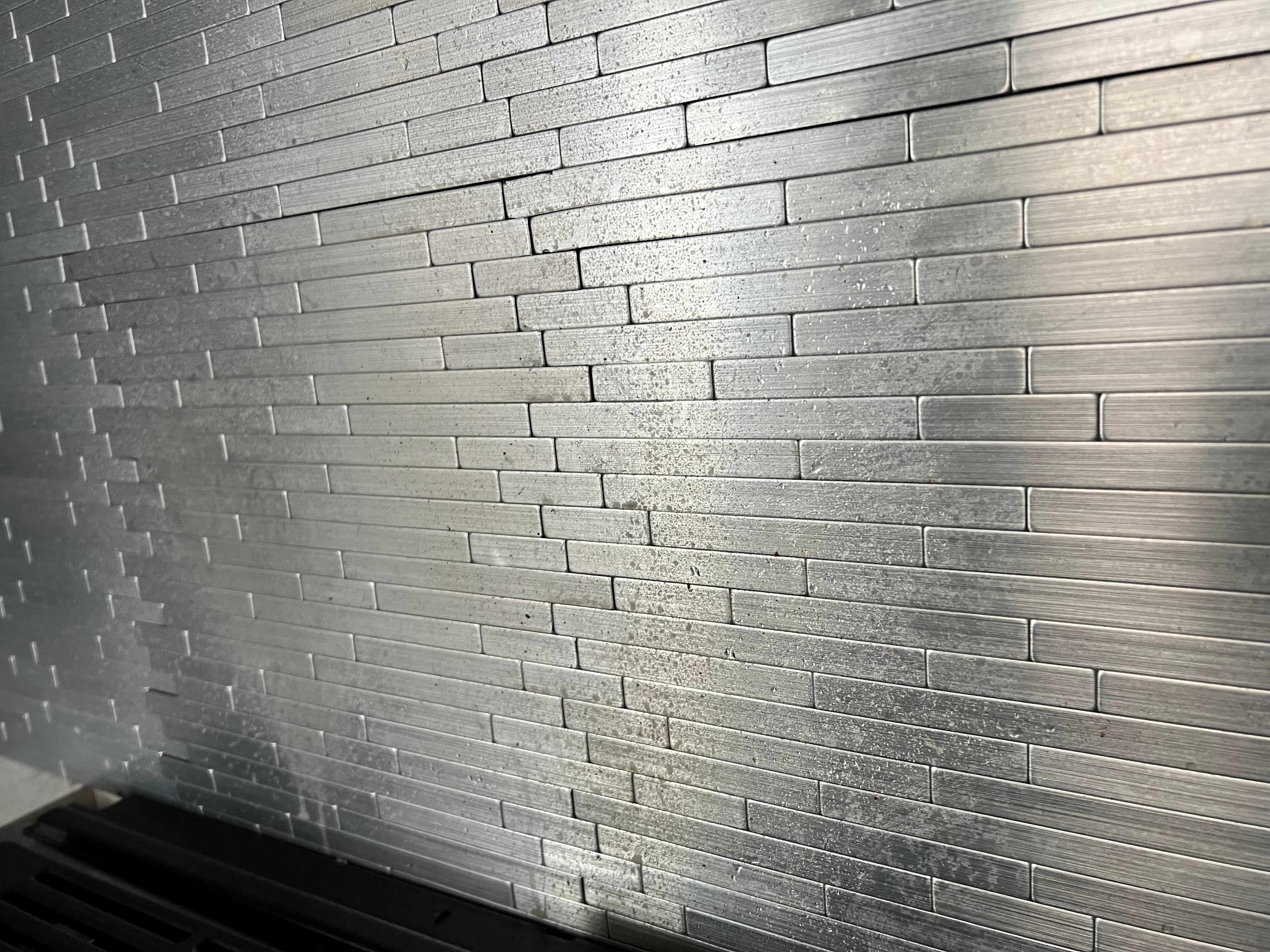 Backsplash of stove covered in grease 
