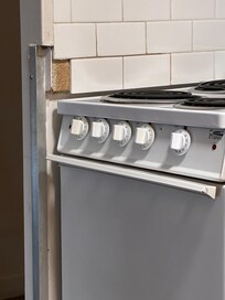 Tile missing on wall in kitchen.