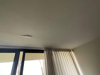 Living room ceiling had paint, texture hanging down