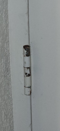 The steel door between rooms, didn't even fit the door jam. It obviously had been kicked in at some point paint missing from hinges never touched up.