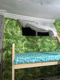 The holes on the wall covered by a lace curtain