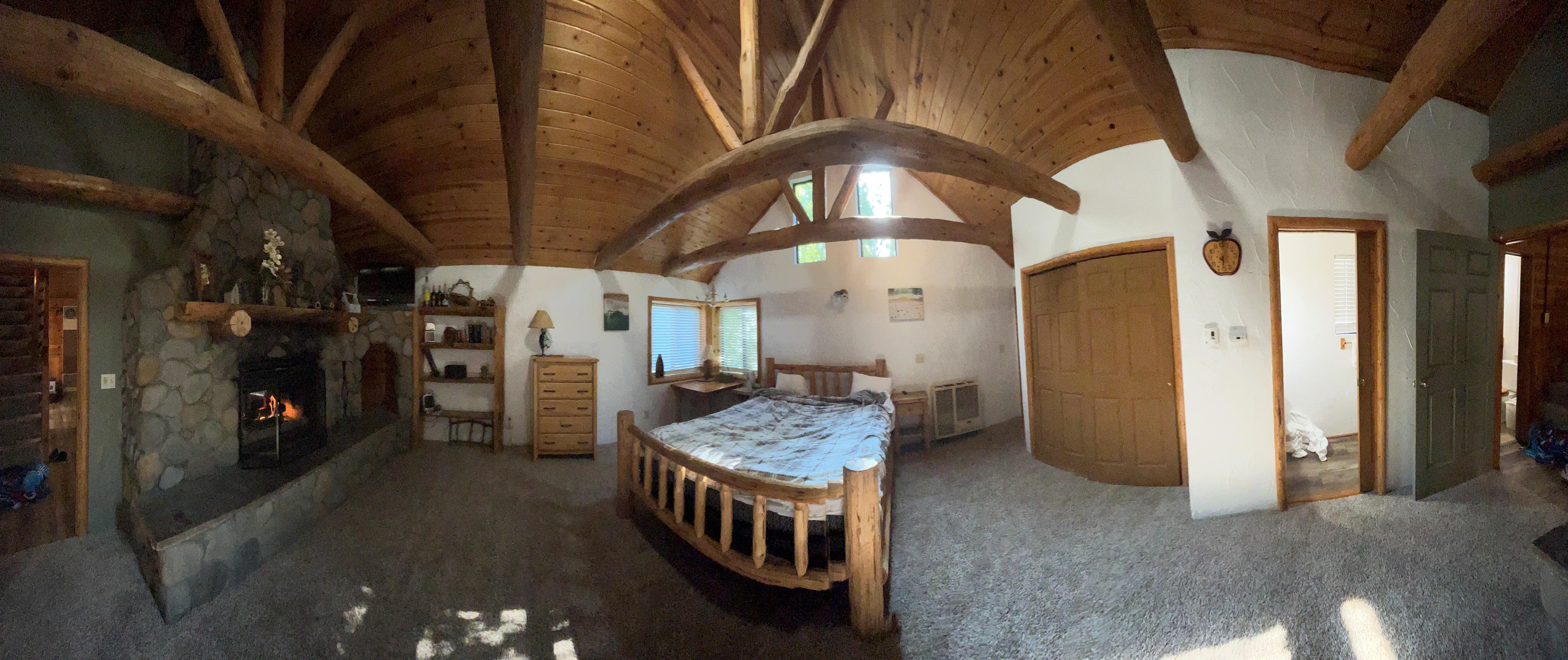 A panoramic view of the Master Bedroom. Contrary to what this site says, this is on the ground level (with the bathroom, Kitchen and Living Room. Upstairs are the other two bedrooms.