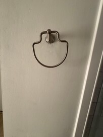 Towel holder “resting” on wall bracket.