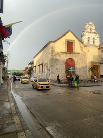 Rainbow after the rain on the side of hotel
