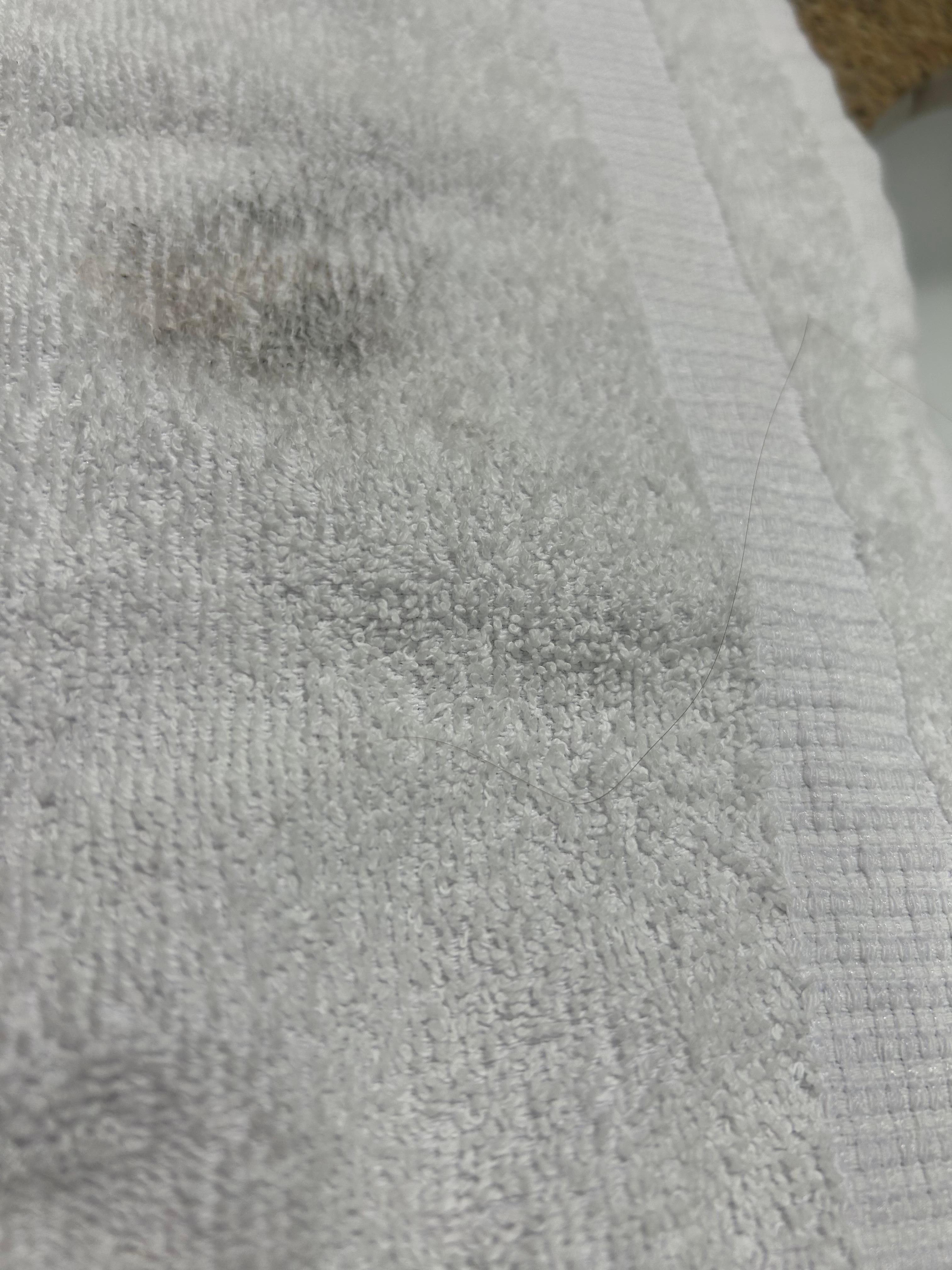 Stain and hair strand on small towel