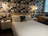 View from the door, on the right is a small desk and a bathroom