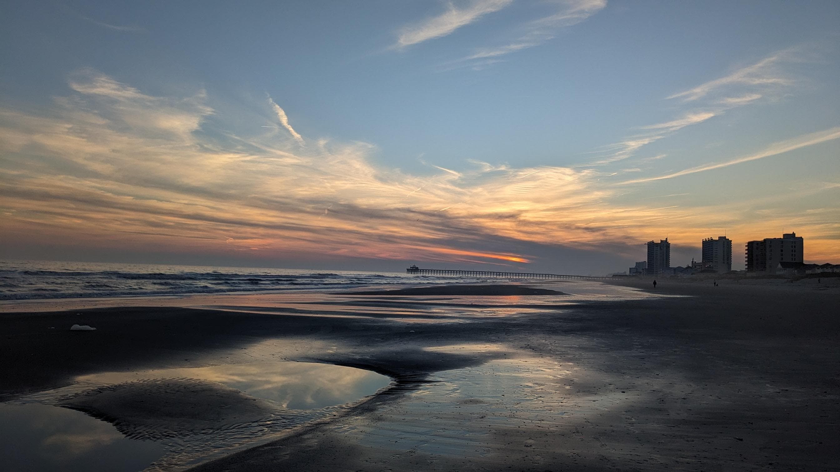 The beach in front of the building.