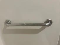 Lotion or soap scum on the grab bar