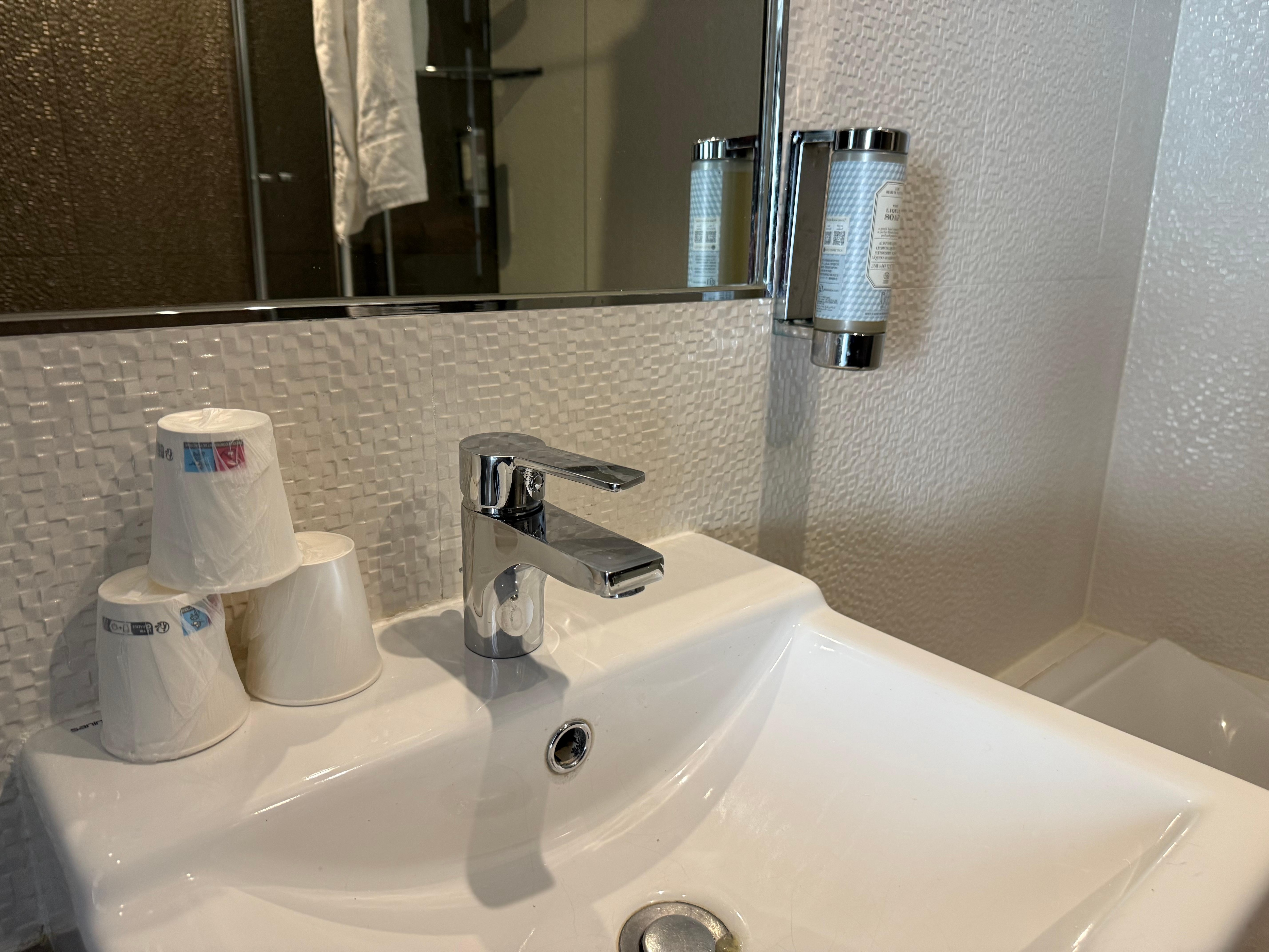 Soap and plastic cups in bathroom