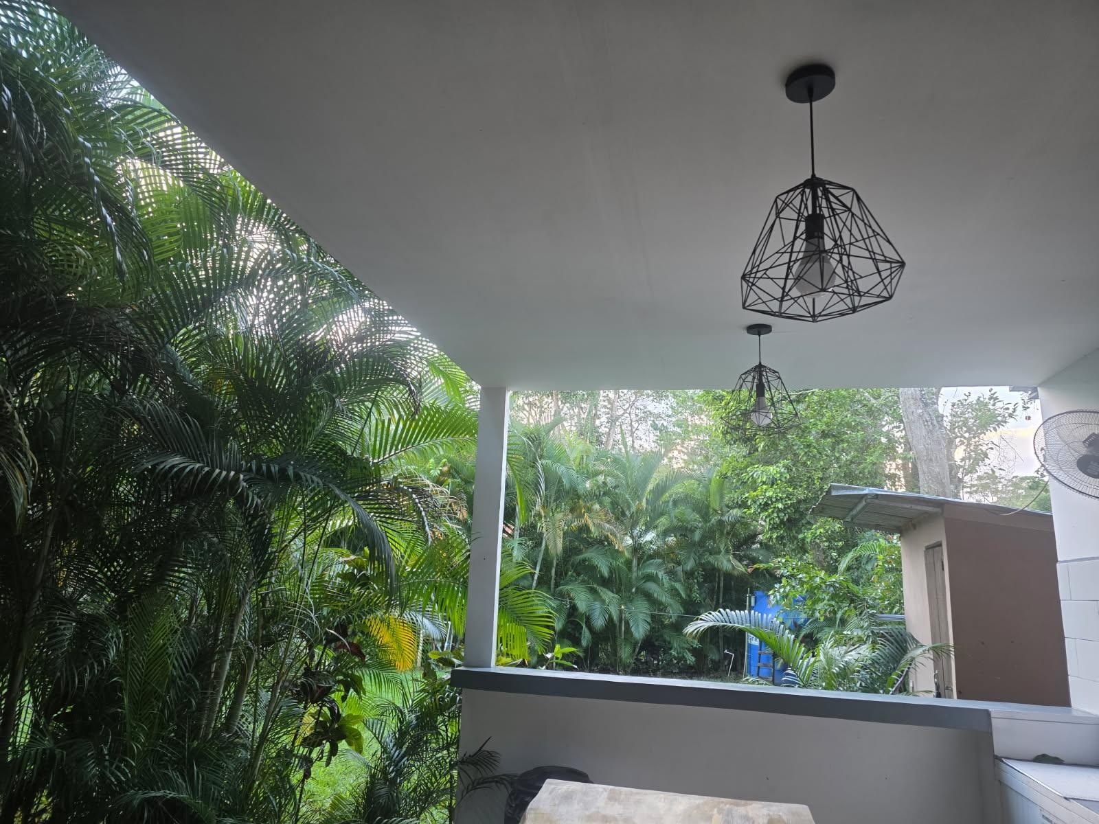 Upper level sitting area with hanging chairs.