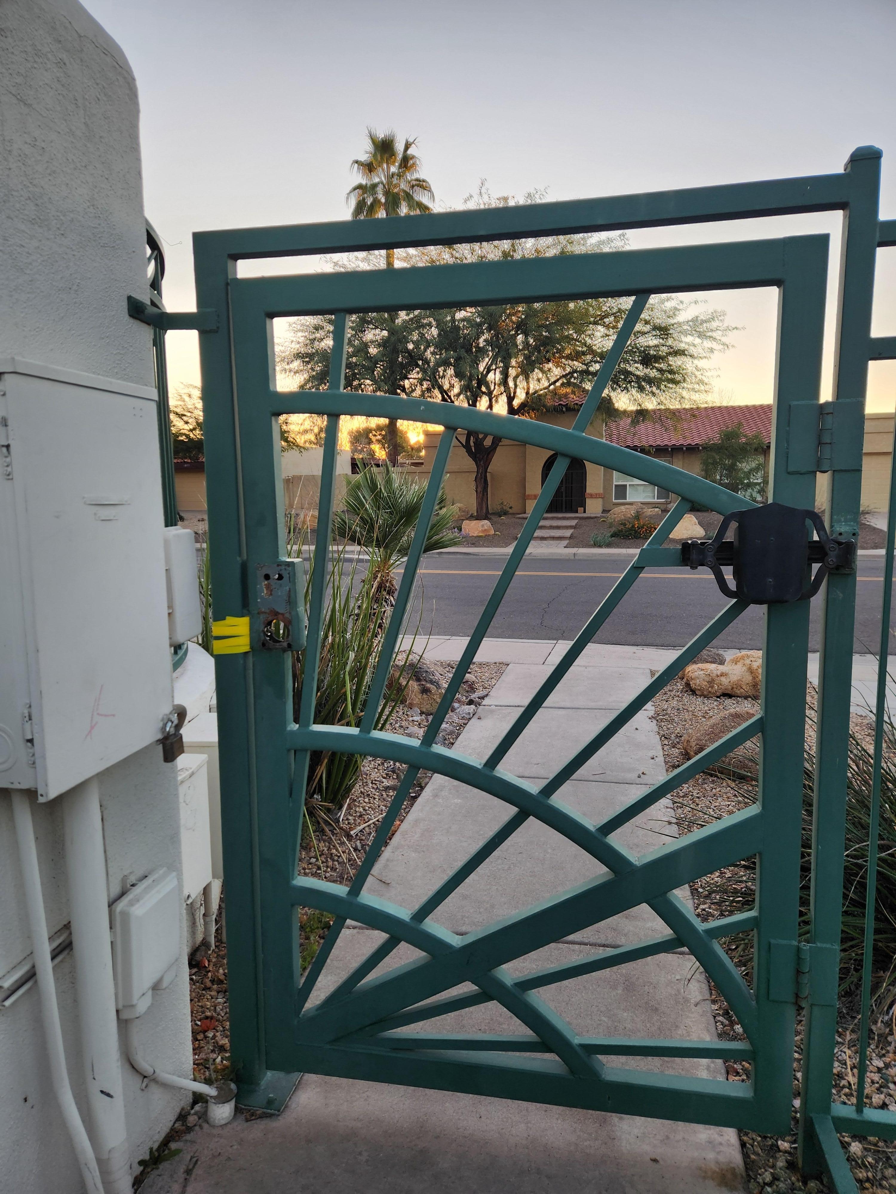 The walk-in gate right next to the home showing there's no handle and no lock. Therefore, it's not a 'gated community' when anyone can walk right in this gate off the street.