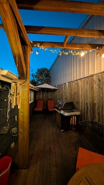 Sitting area of cottage at dusk with sitting lights (BBQ area).