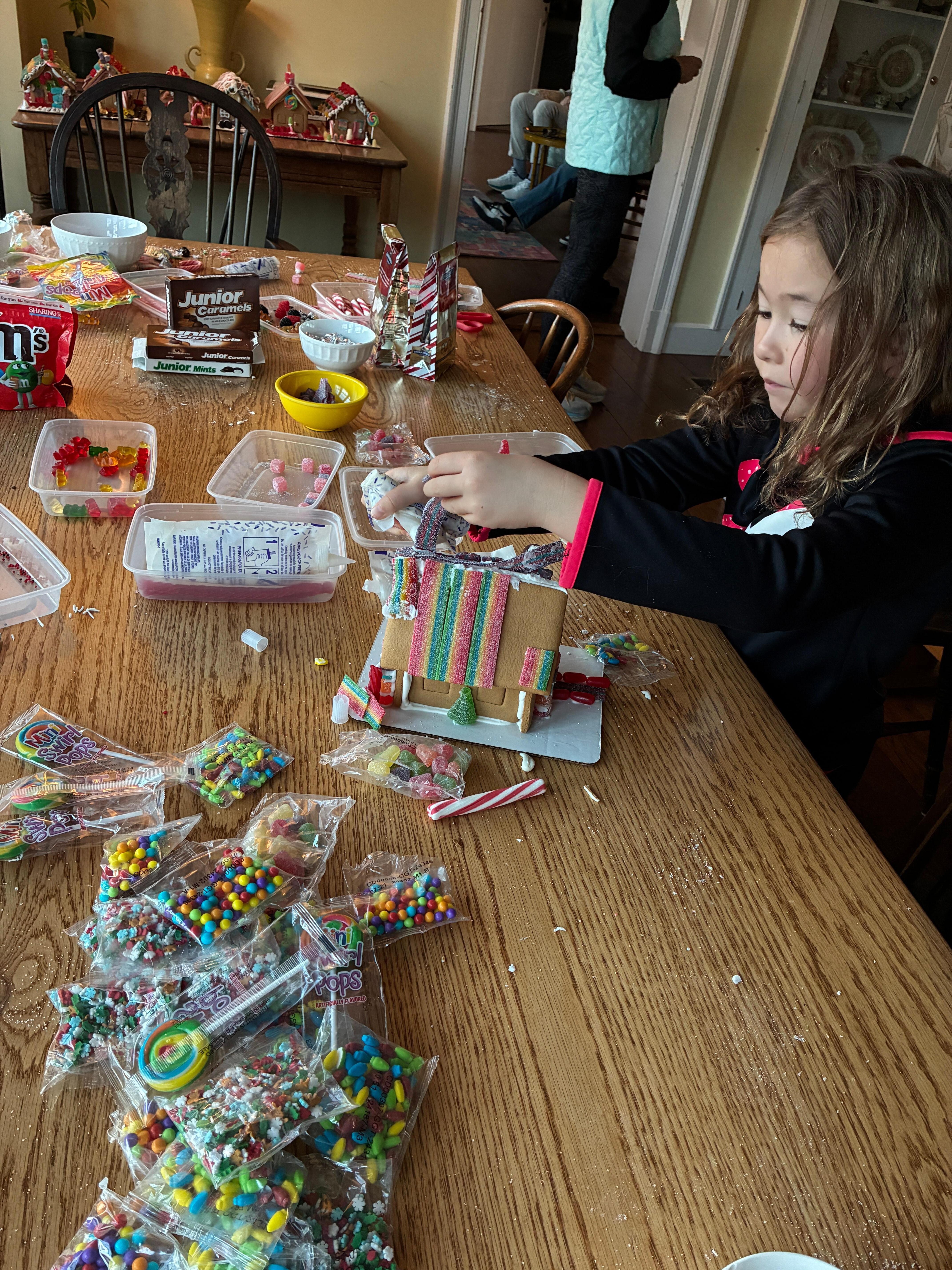 Decorating gingerbread houses on Thanksgiving Eve