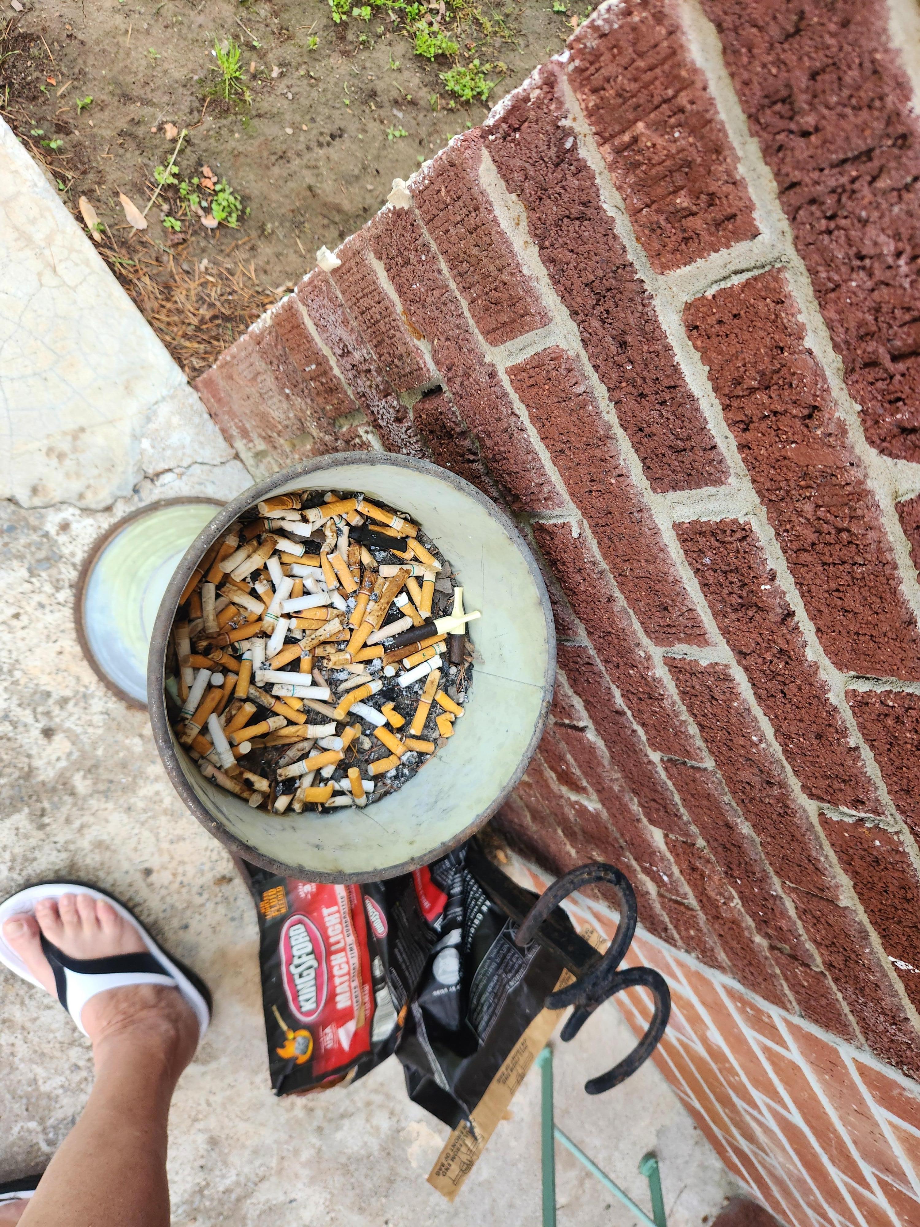 Outside half full cigarett butt can