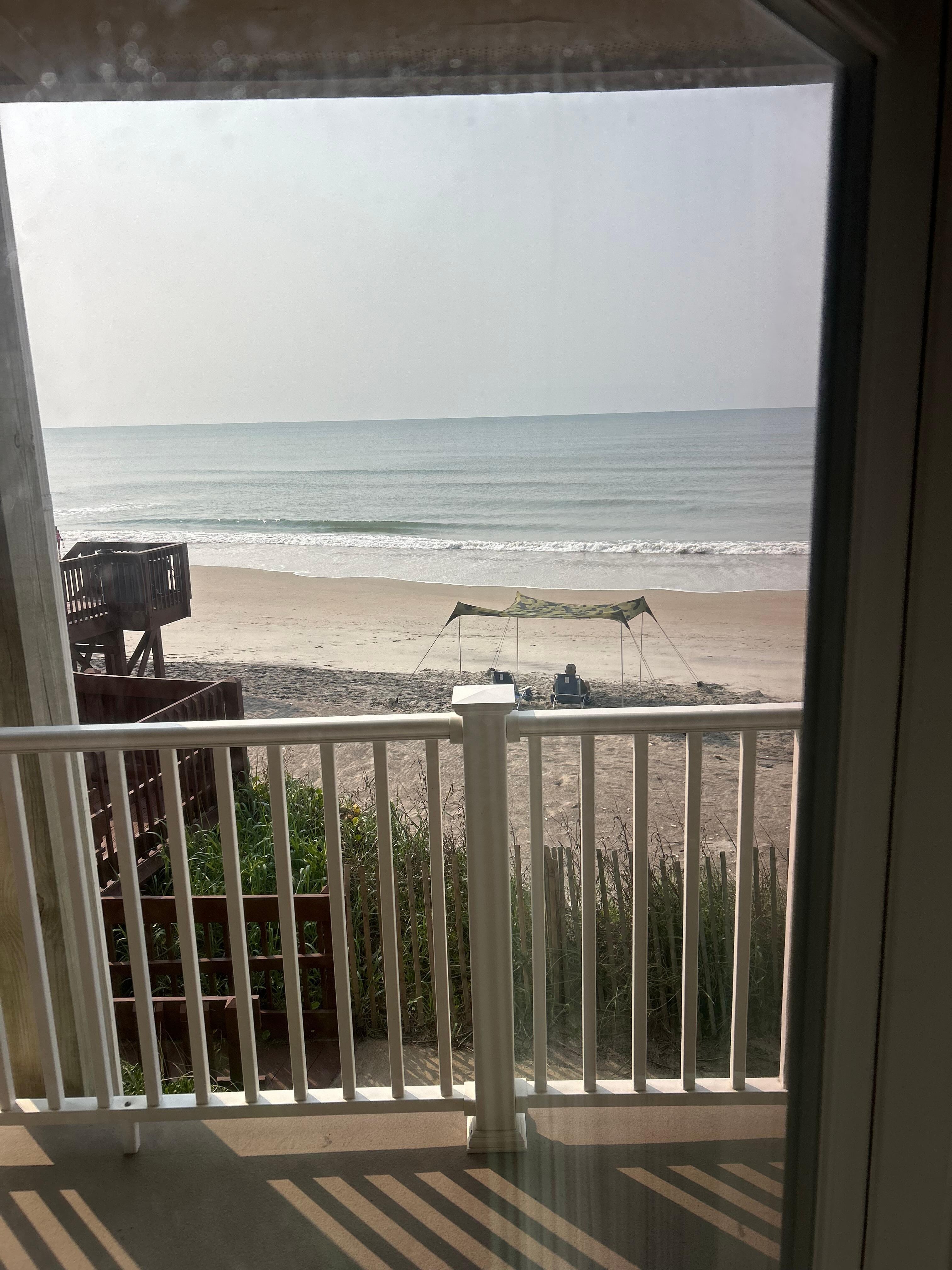Looking out the patio window, the beach is literally right there! 