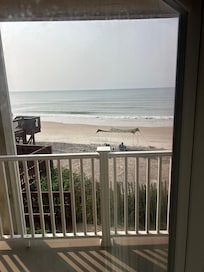 Looking out the patio window, the beach is literally right there!