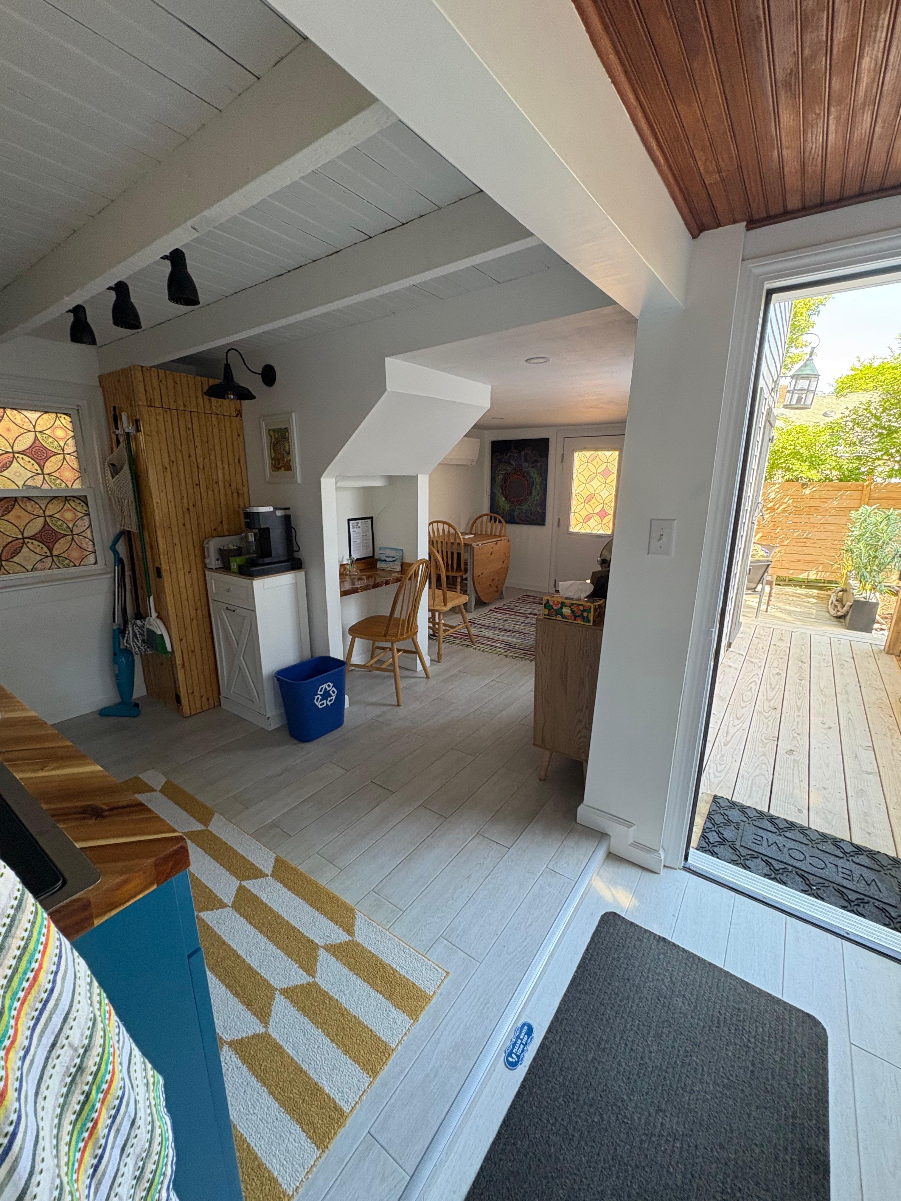Standing in the foyer looking out at the sunny porch - other doorway to the large patio.