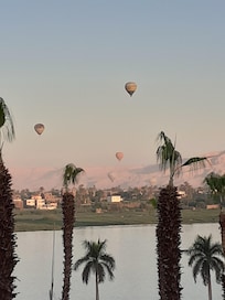 Balloons launching over the Valley of the Kings as seen from balcony at sunrise.