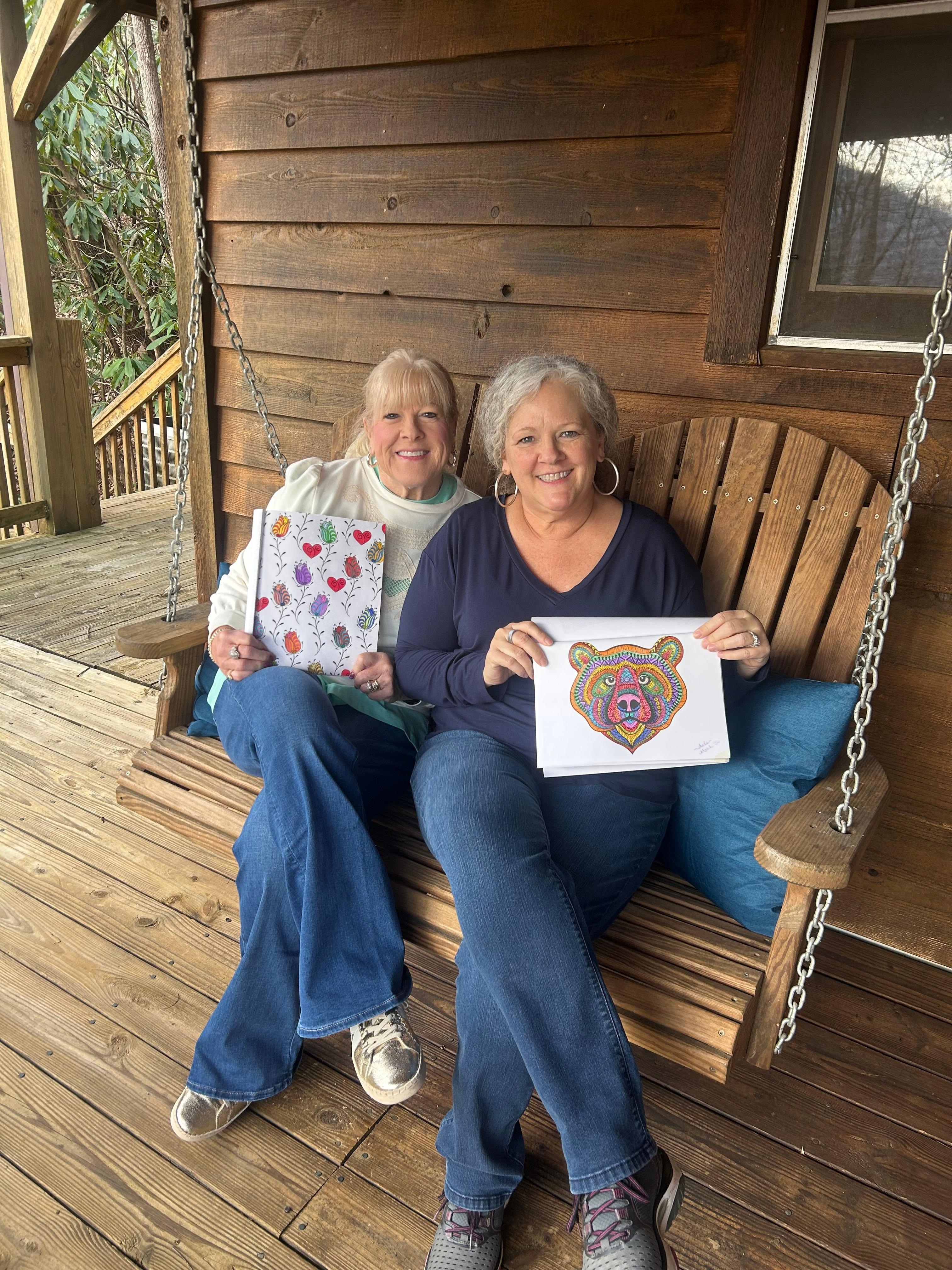 Showing off our adult coloring pics on the porch swing. 