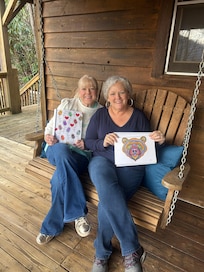 Showing off our adult coloring pics on the porch swing.