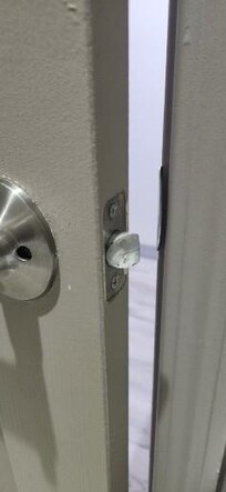 Backwards bathroom door handle. As you can see it will not close and lock, imposable. If the door opened the other way, it would.