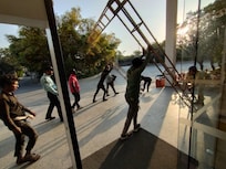 Lifting heavy metal frame while guests coming in and out inside hotel