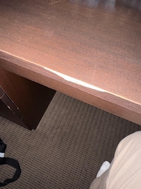 Siding of desk top that needs to be repaired.