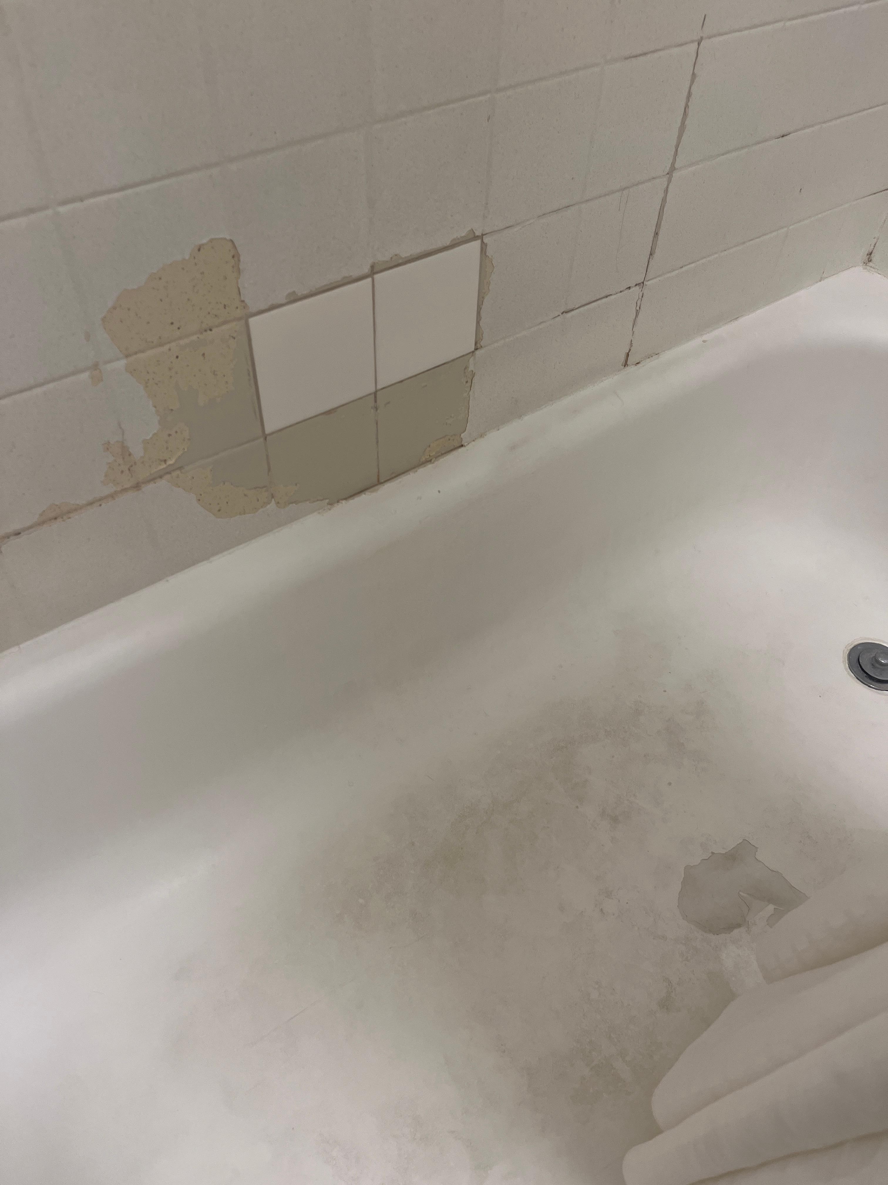 Bad tiling. Needs to be replaced. Look at that soap scum on the floor.