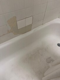 Bad tiling. Needs to be replaced. Look at that soap scum on the floor.