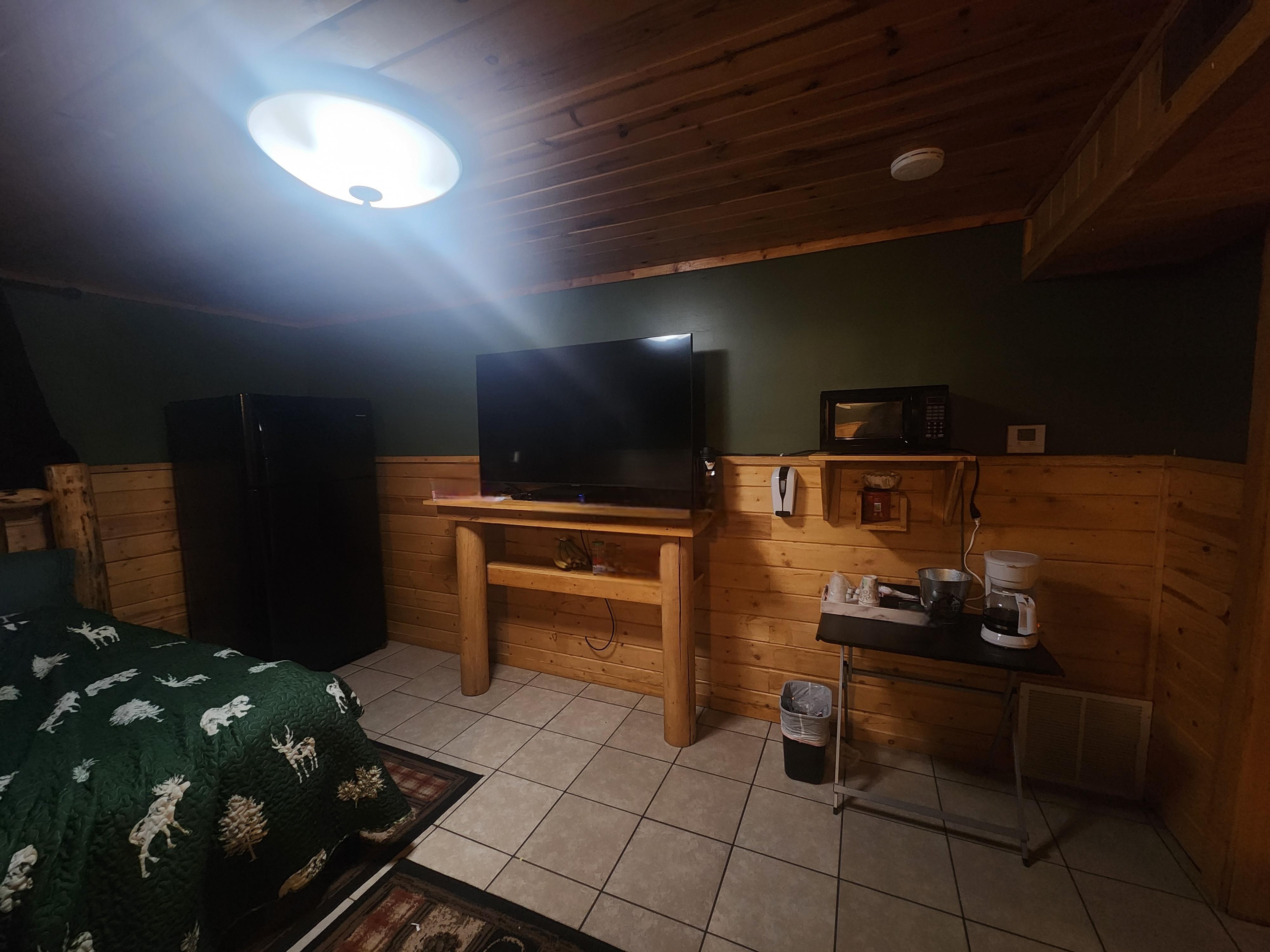 Main bed/fridge area from first bedroom side.