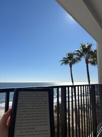 Comfortable chairs and a couch can be found on this large balcony that is perfect for reading while sipping morning coffee!