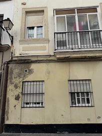 The obvious water damage to the wall; the bedroom is the top left window