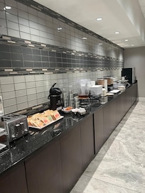 Large buffet wall with everything from cereal to juice, to eggs, biscuits and gravy, sausage, and so much more. Only thing that would have made it perfect would have been some crispy bacon.